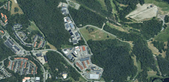 Drönarbild över ett industriområde med skog runtom.