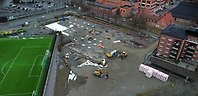 Drönarbild över området med hus en stor gräsplan och ett bygge.
